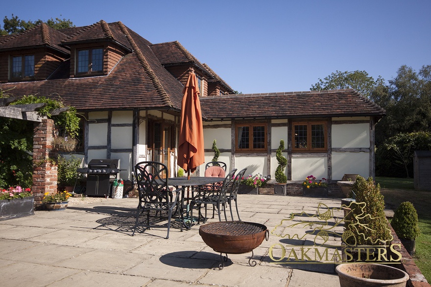 Outside view of re-claimed oakframe dining room extension of family home 