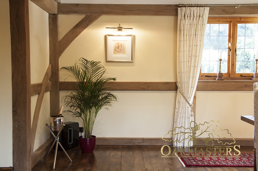 Detail of exposed structural oakframe wall in dining room extension