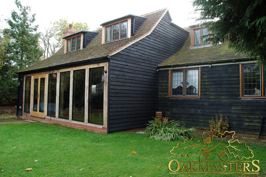 Exterior of oak frame and oak-clad sitting room extension