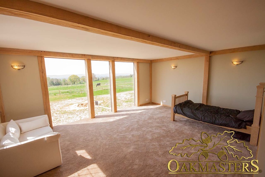 Simple oak framed window and minimal beams in country house