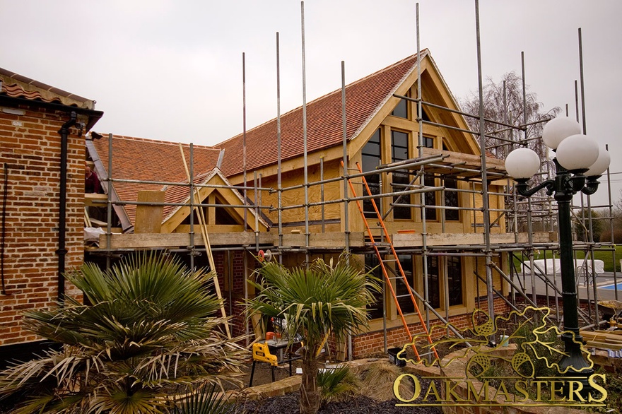 Glazed gable end under projecting roof on large extension to be completed