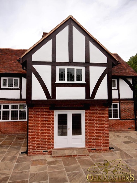 Gable end with exposed timber frame on listed house extension