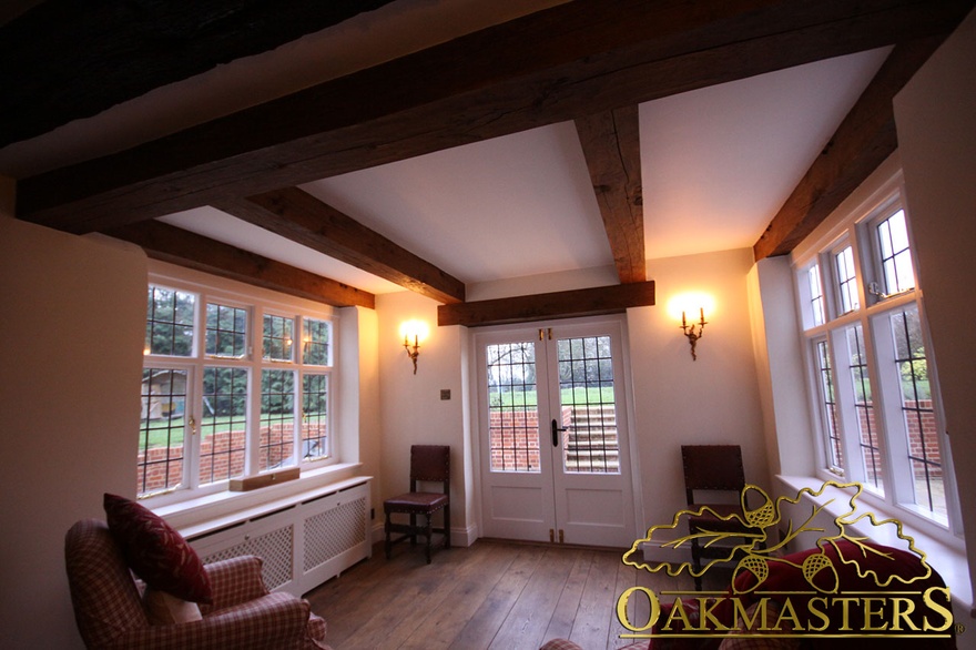 Straight oak ceiling beams and door lintel in listed house entrance hall