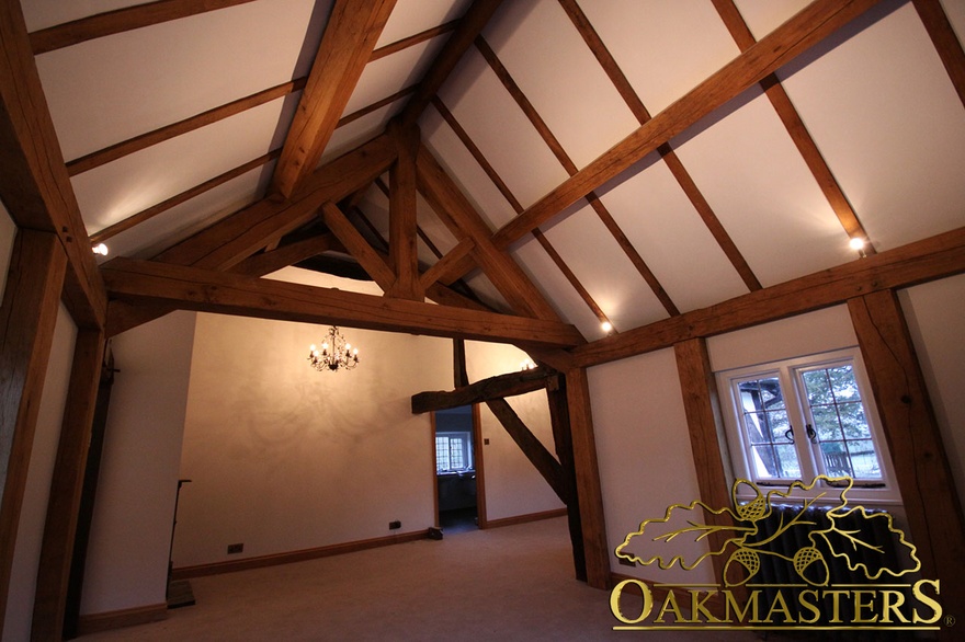 Evening light enhances exposed king post truss as feature in listed hallway