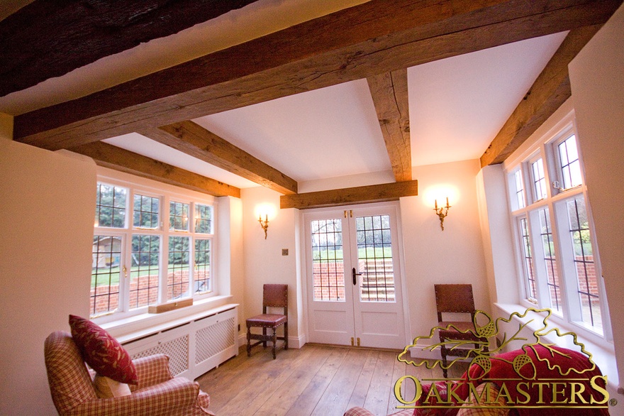 Straight oak ceiling beams and door lintel in listed house entrance hall