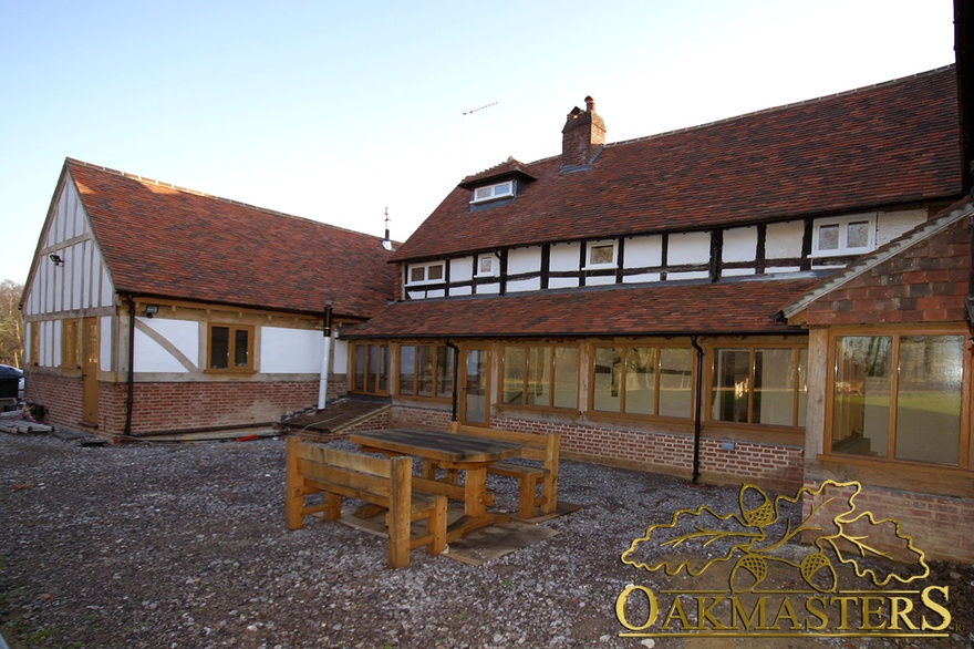 Exterior of listed house with hand made oak cladding and glazed extension