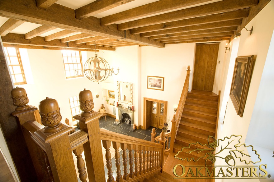 Aerial view of butterfly staircase beneath manx oak ceiling beams