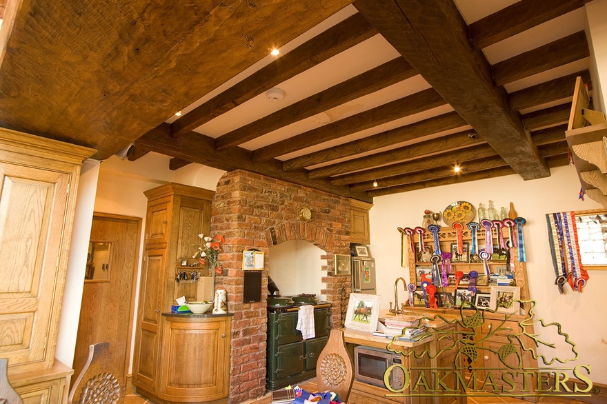 Spotlights on manx oak ceiling beams in kitchen