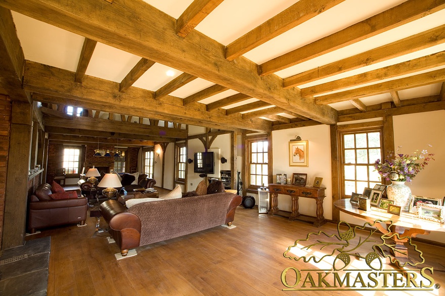 Sitting room in Isle of Man manx oak and stone house with exposed ceiling beams and oak-frame windows