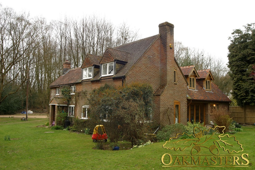 Modern extension with oak frame dormer windows and patio glazed doors on country house