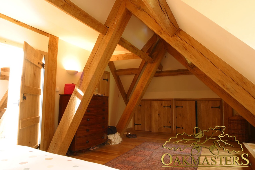 Loft bedroom with integrated storage with oak doors in modern extension