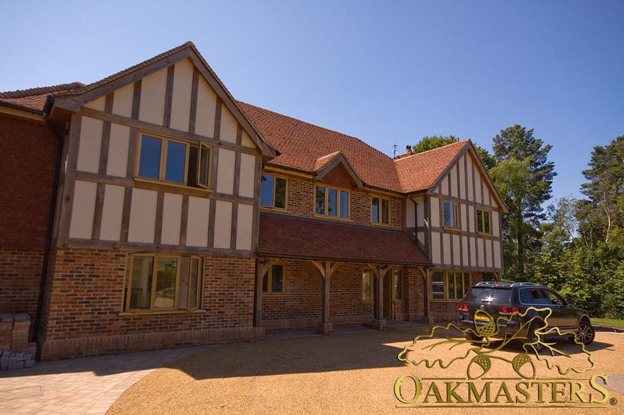 Exterior of modern home with oak frame porch and windows