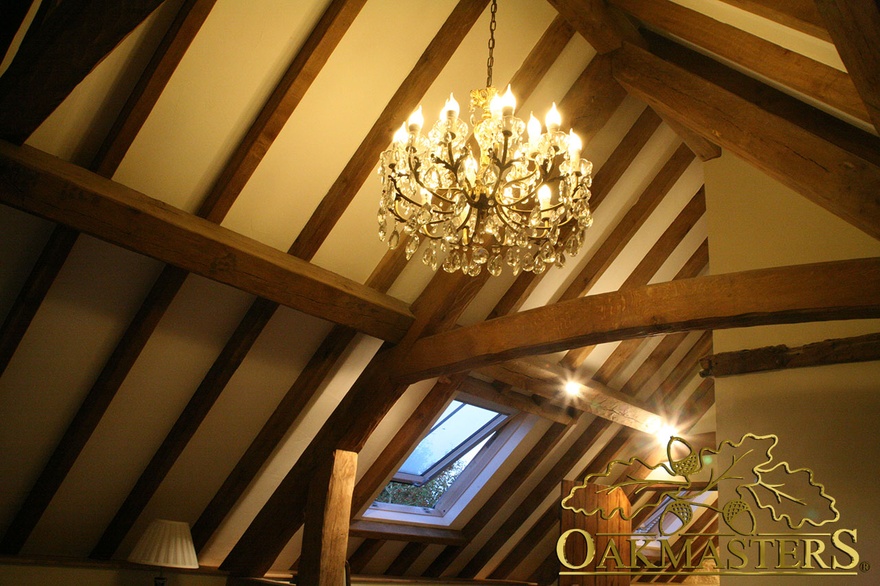 Chandelier amongst exposed oak rafters, Restoration Man televison project