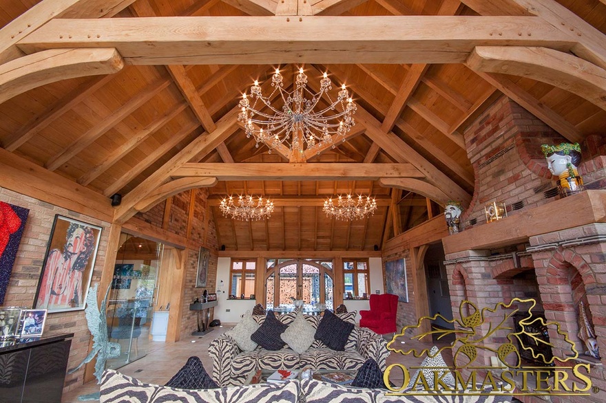 Sitting room with brick and oak mantel fireplace and exposed oak open ceiling and chandelier lighting