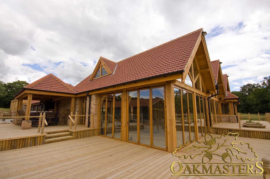 Dual aspect oak frame glazing leading to patio and outside oakframe shelter