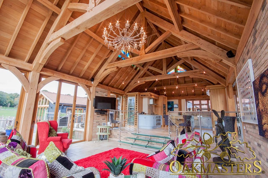 View from family living area to bespoke kitchen in spacious oak frame single storey residence