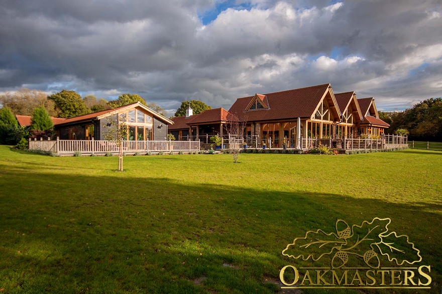 Exterior of single storey country residence with featheredge oak cladding, exposed oak frame and tiled roof