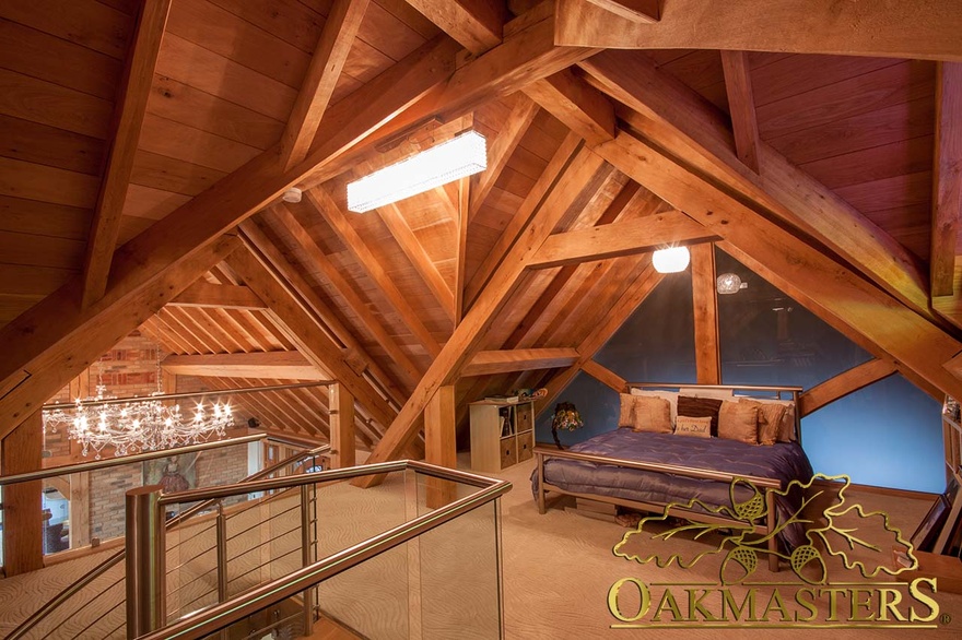 Mezzanine bedroom beneath exposed oak ceiling rafters with glazed balcony and staircase 