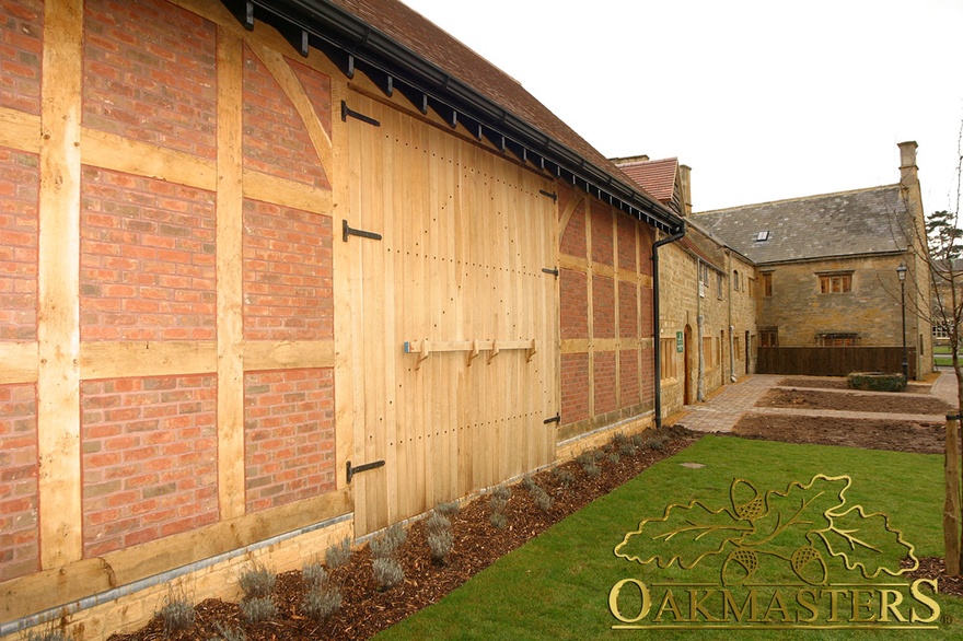 Barn door with wooden latch between oak frame wall form part of supermarket