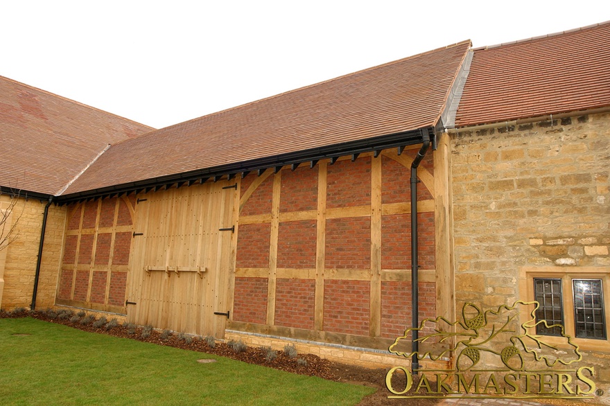 Barn style exposed oak frame brick and stone supermarket building