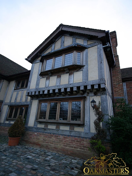 Oak framed windows and timber cladding in tudor style on new build residence