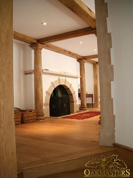 Circular oak columns and beams surround fireplace