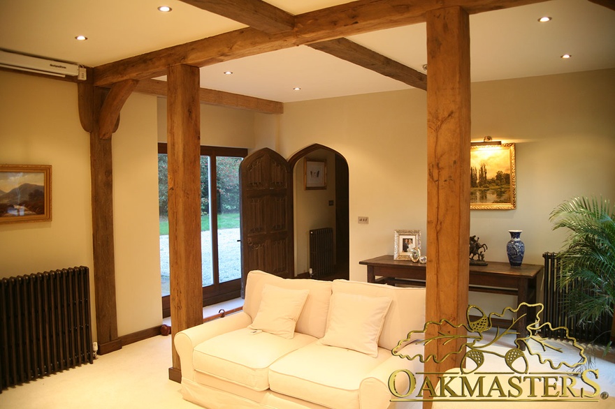 Simple oak posts supporting oak ceiling beams  create a frame for this sofa - 175228