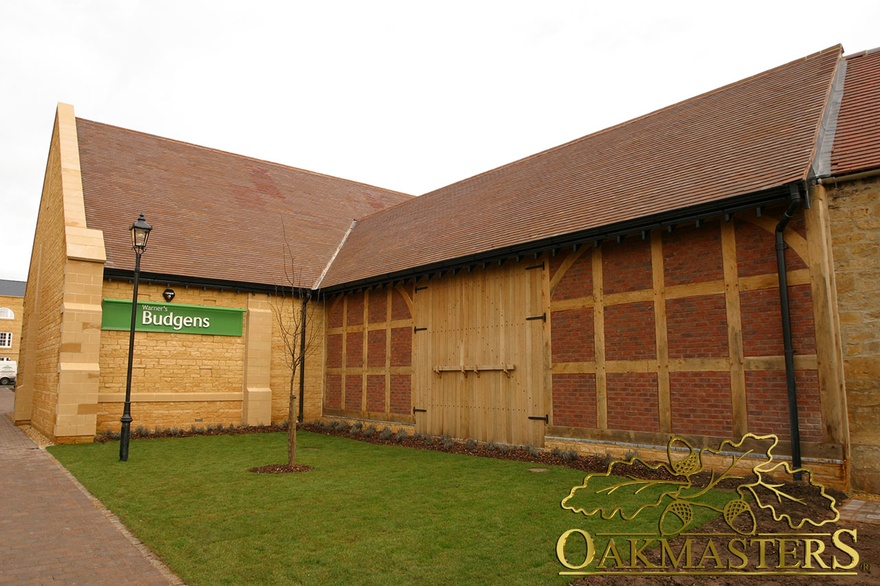 Oak cladding makes this supermarket look like an oak barn