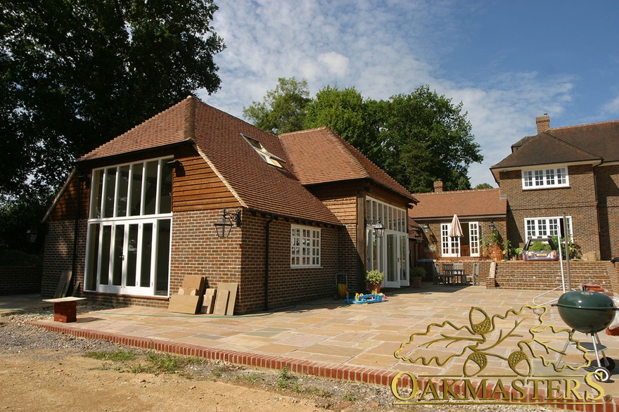 Oak framed pool house with brick exterior