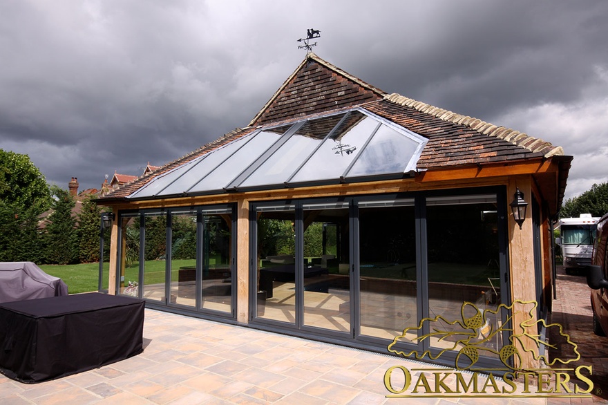 Oak framed pool house with glazed front and roof