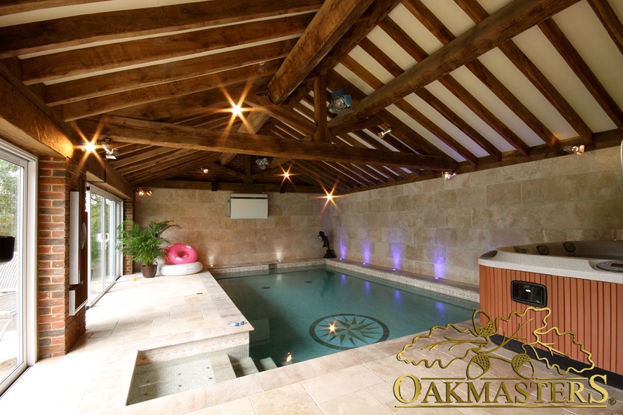 Exposed vaulted roof in oak and stone poolhouse and gym