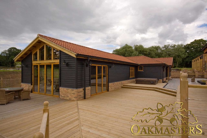 Oak clad pool building with oak frame glazing