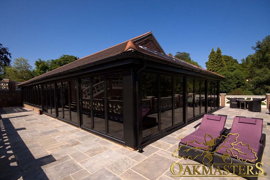 Glazed windows of pool house with vaulted roof