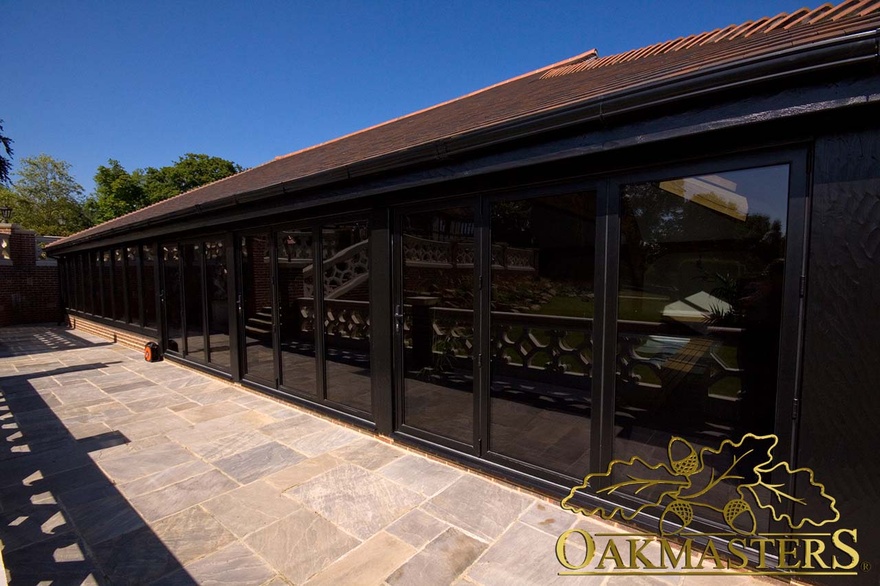 Full height glazing and patio area surround pool house