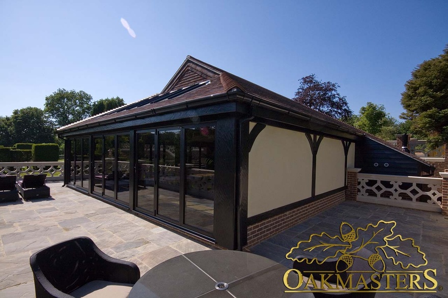 Exterior of pool house with impressive vaulted roof