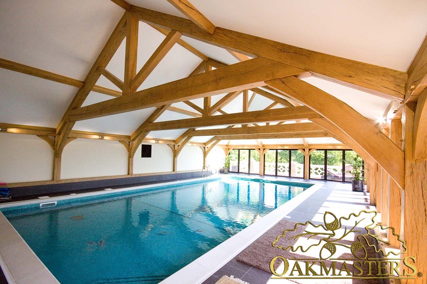 Impressive light filled pool house with vaulted oak roof