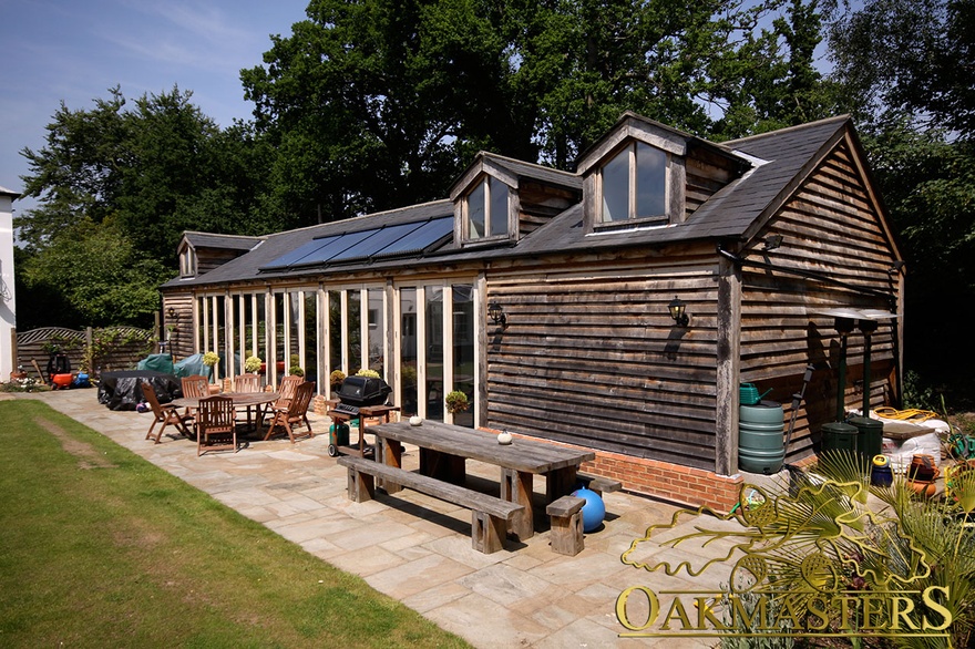 Detached oak-clad and glazed poolhouse with internal gallery