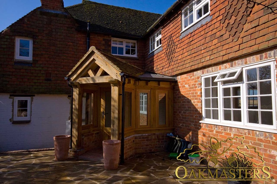 Oak porch built in the corner of a house