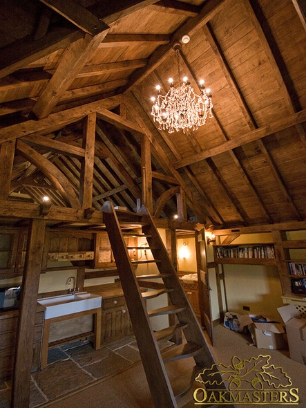 Exposed oak roof and complex queen post trusses with a loft ladder