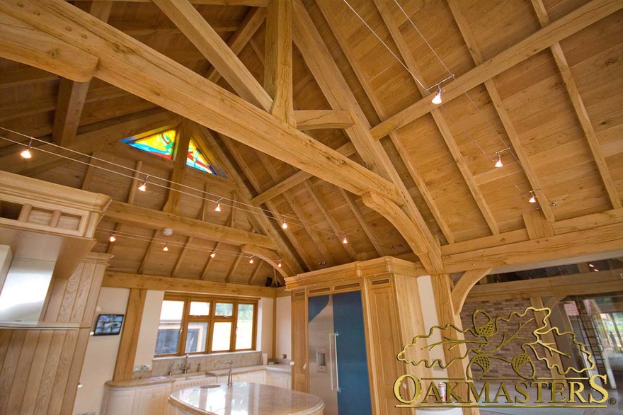 Handmade oak kitchen beneath raised tie trusses