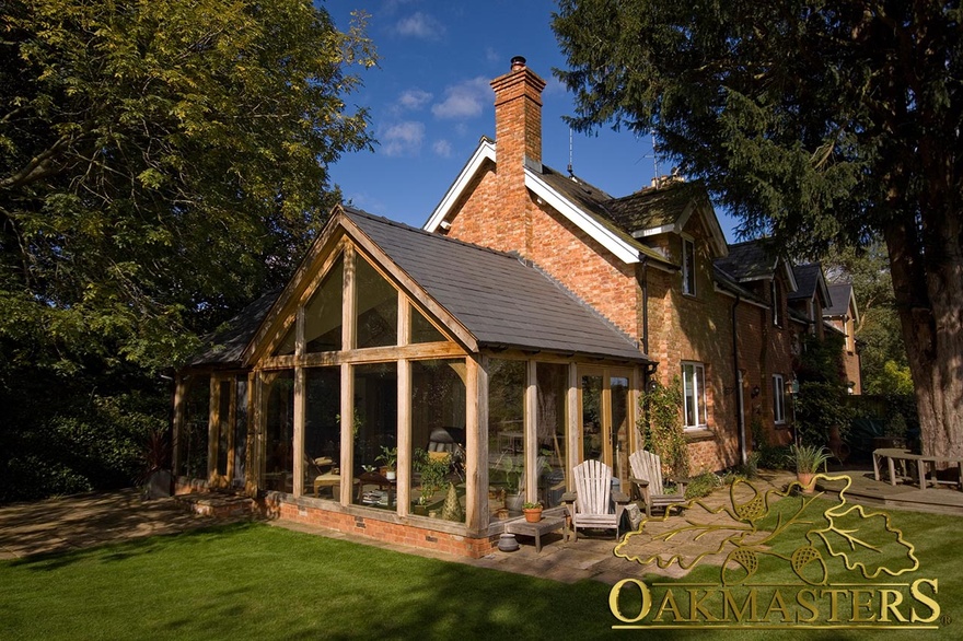 Fully glazed dual aspect garden room built to match existing cottage