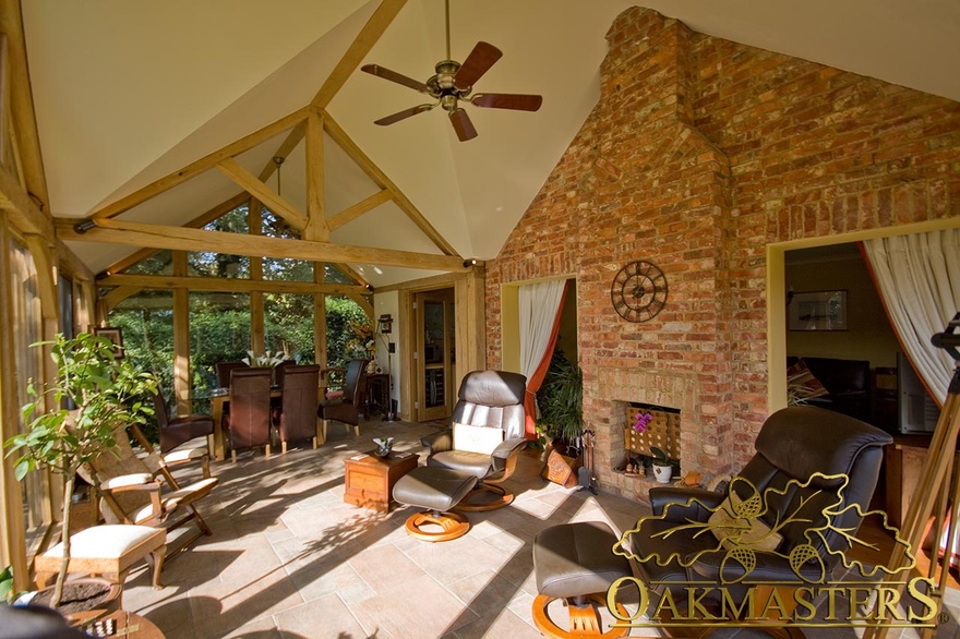 Existing cottage wall integrates with fully glazed garden room built to match cottage