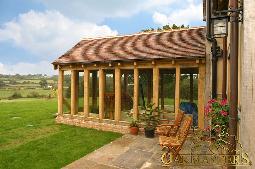 Side exterior of oak frame fully glazed garden room