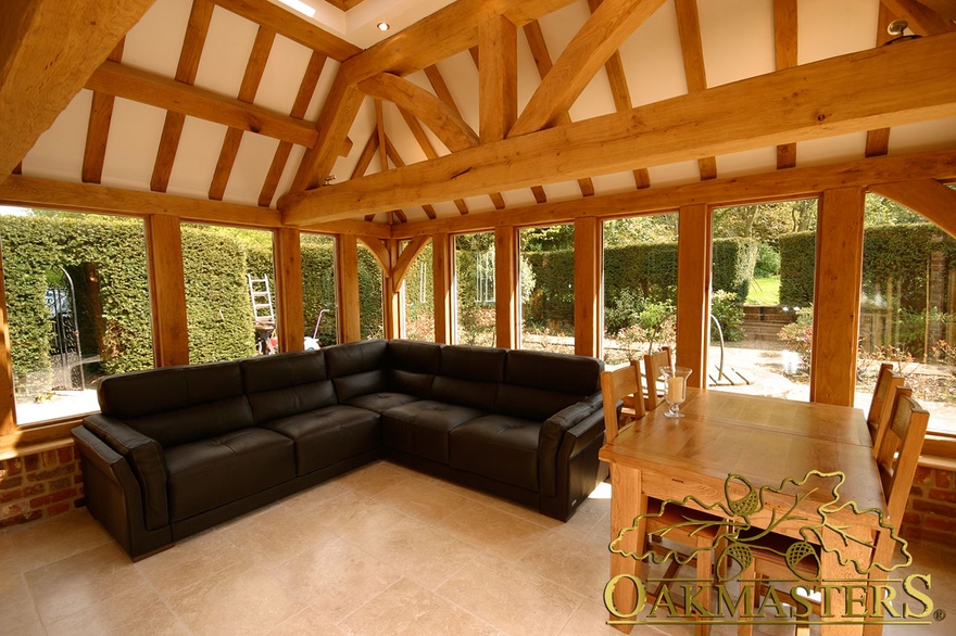 Seating area with views in part glazed orangery on listed manor house