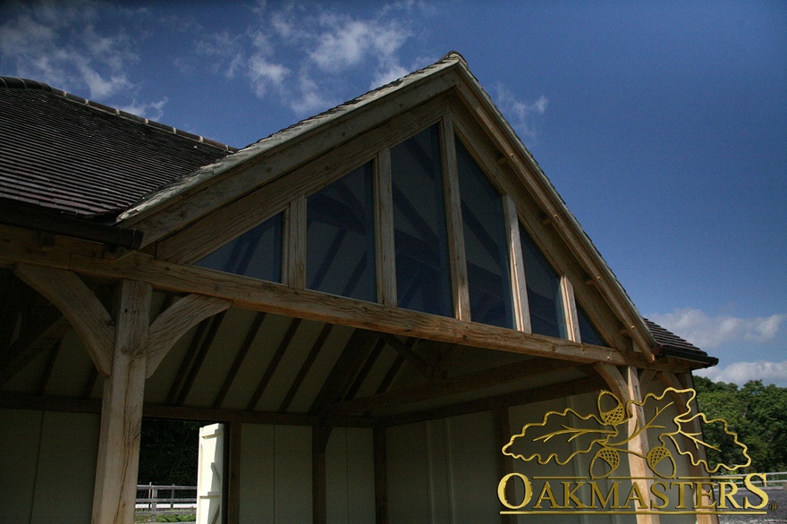 Exposed oak frame glazed gable and curved oak braces of amenity building