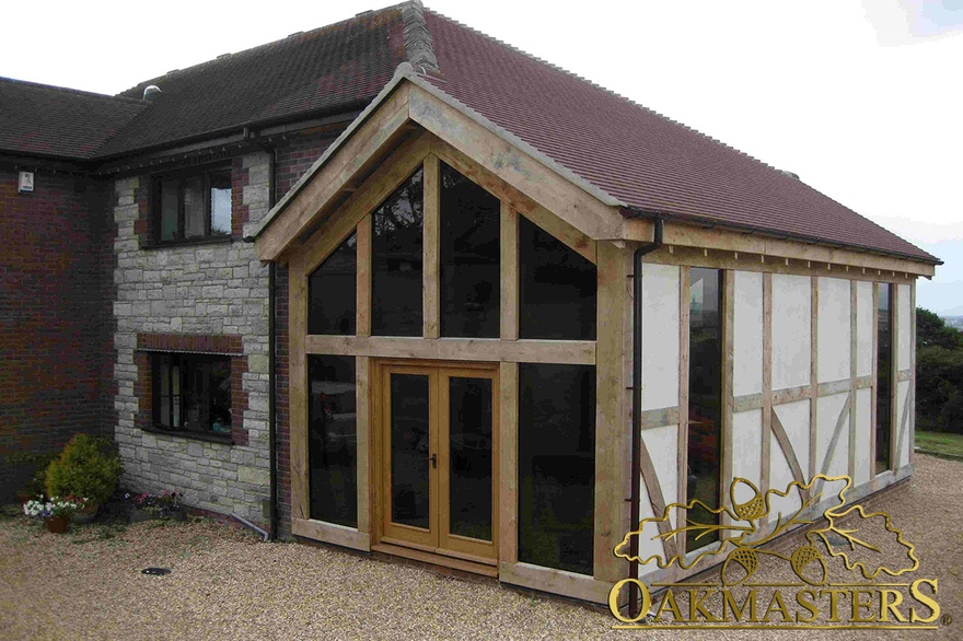 Oak frame glazed gable extension integrated with existing house on Isle of Wight