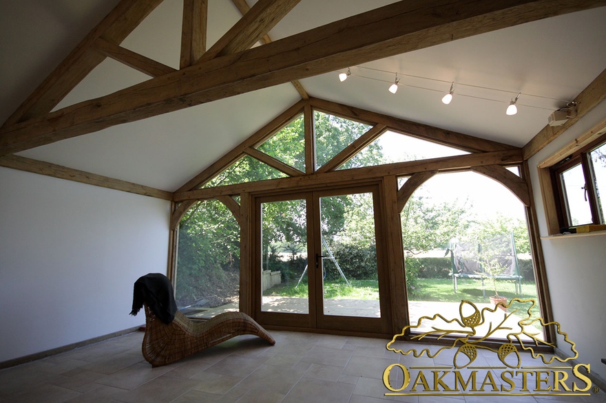 Interior garden room and garage complex with vaulted ceiling and fully glazed gable end