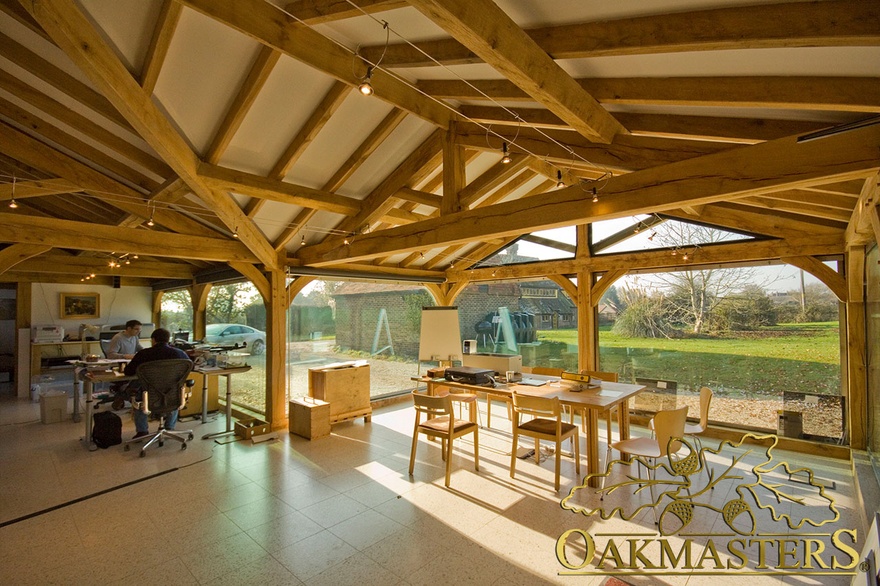 Exposed oak-frame vaulted roof truss and rafters in glazed garden room office
