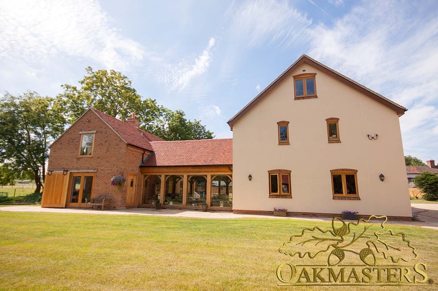 Rear exterior of fully glazed link building with oak frame and tile roof