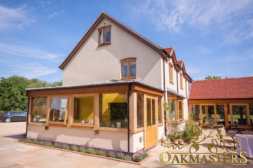 Exterior of glazed link building and oak framed sunroom